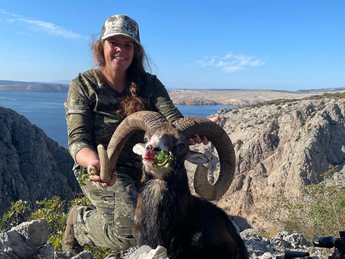 Hunter taking picture with his hunted mouflon in Croatia, example of successful client of Teron who went mouflon hunting in Croatia